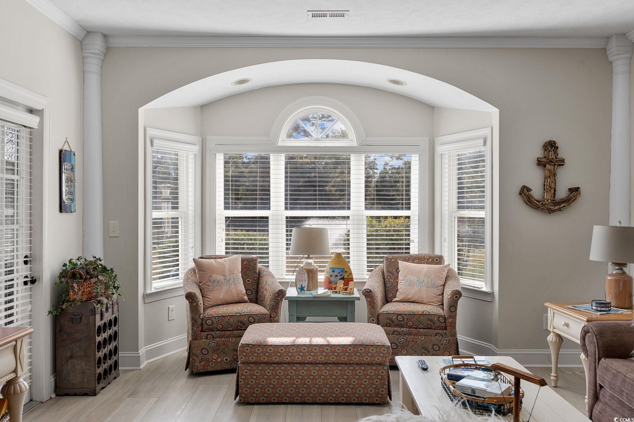 121 Waypoint Ridge Avenue, Unit P8 Little River, SC 29566 - Photo 13 of 40 Living area featuring ornate columns, light wood-type flooring, and ornamental molding