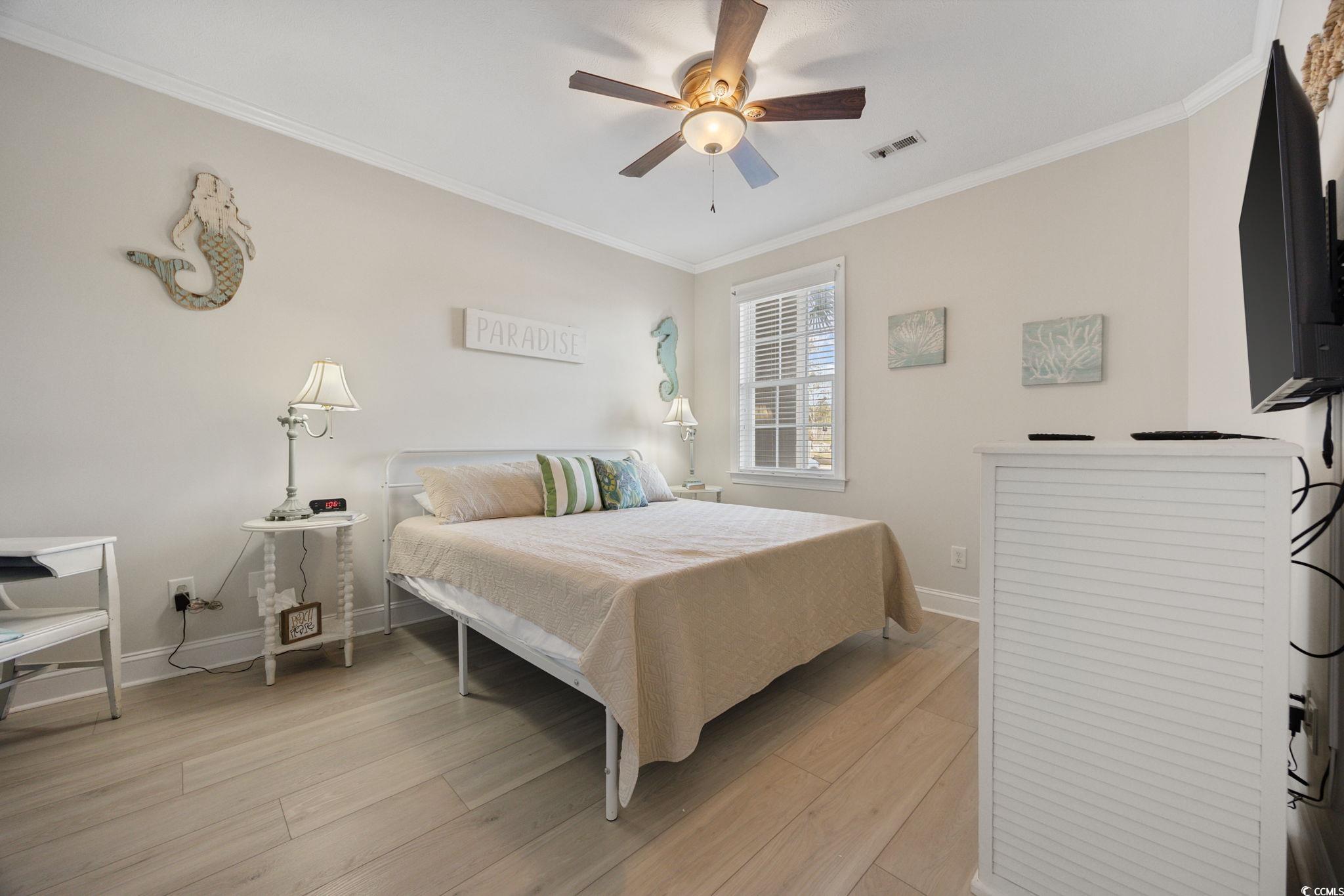 121 Waypoint Ridge Avenue, Unit P8 Little River, SC 29566 - Photo 16 of 40 Bedroom featuring crown molding, light wood-style flooring, and a ceiling fan