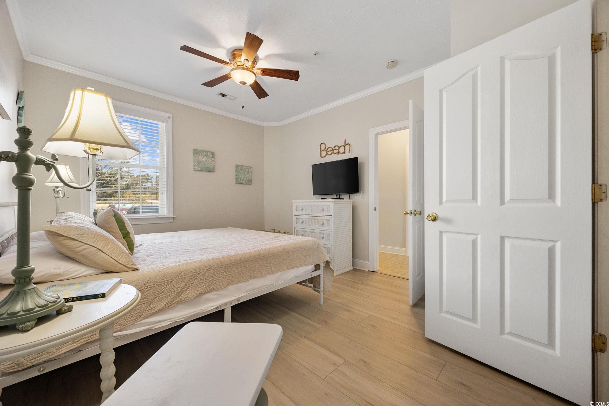 121 Waypoint Ridge Avenue, Unit P8 Little River, SC 29566 - Photo 17 of 40 Bedroom with ornamental molding, light wood-style floors, and ceiling fan