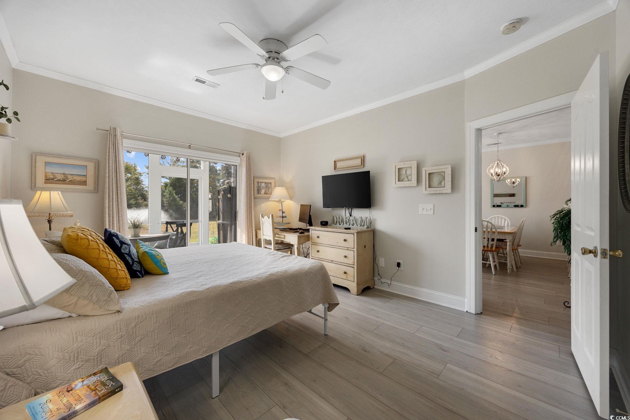 121 Waypoint Ridge Avenue, Unit P8 Little River, SC 29566 - Photo 18 of 40 Bedroom with ornamental molding, light wood-type flooring, access to exterior, and ceiling fan