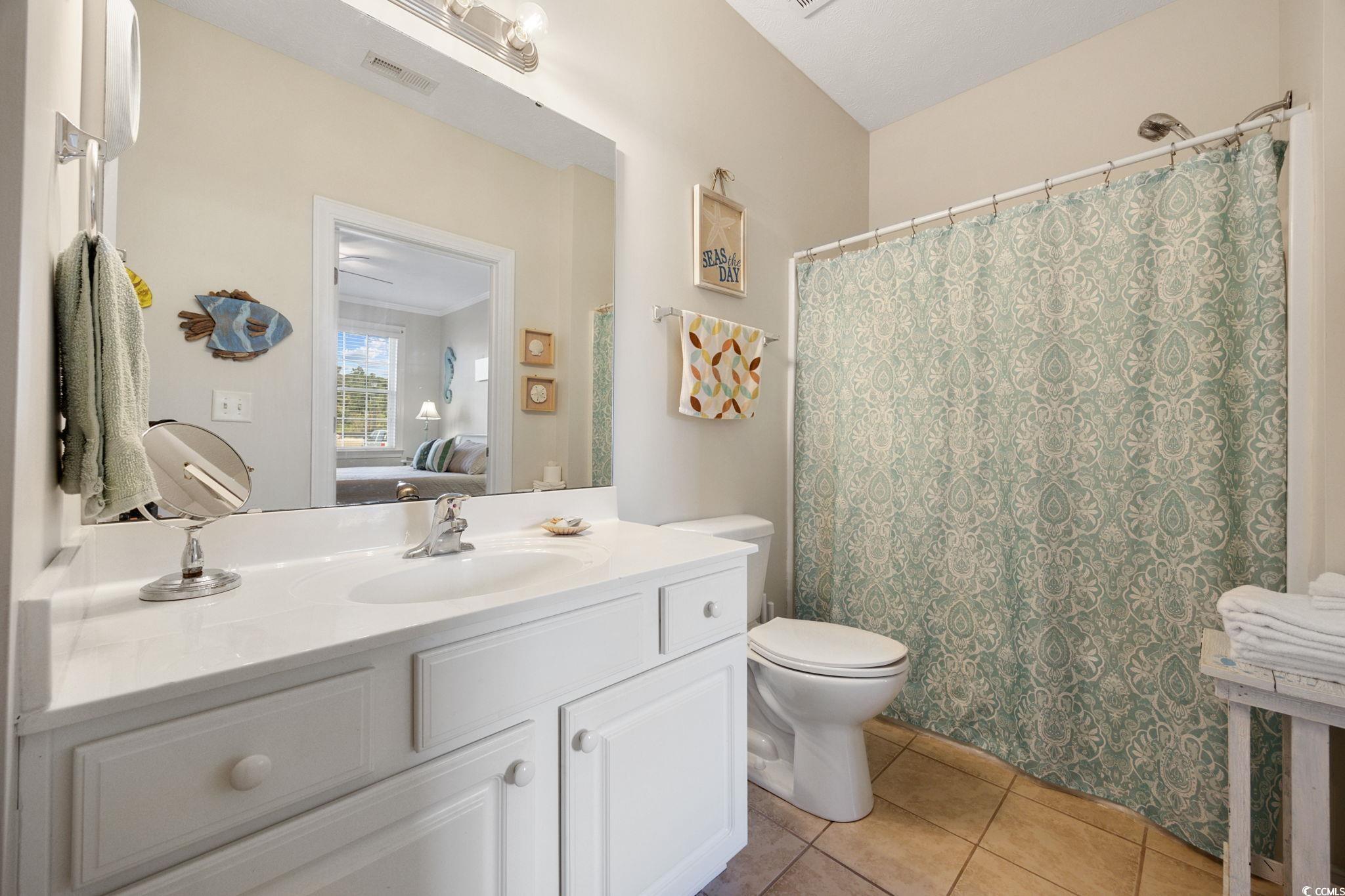 121 Waypoint Ridge Avenue, Unit P8 Little River, SC 29566 - Photo 22 of 40 Bathroom with a shower with curtain, ensuite bathroom, vanity, and light tile patterned floors