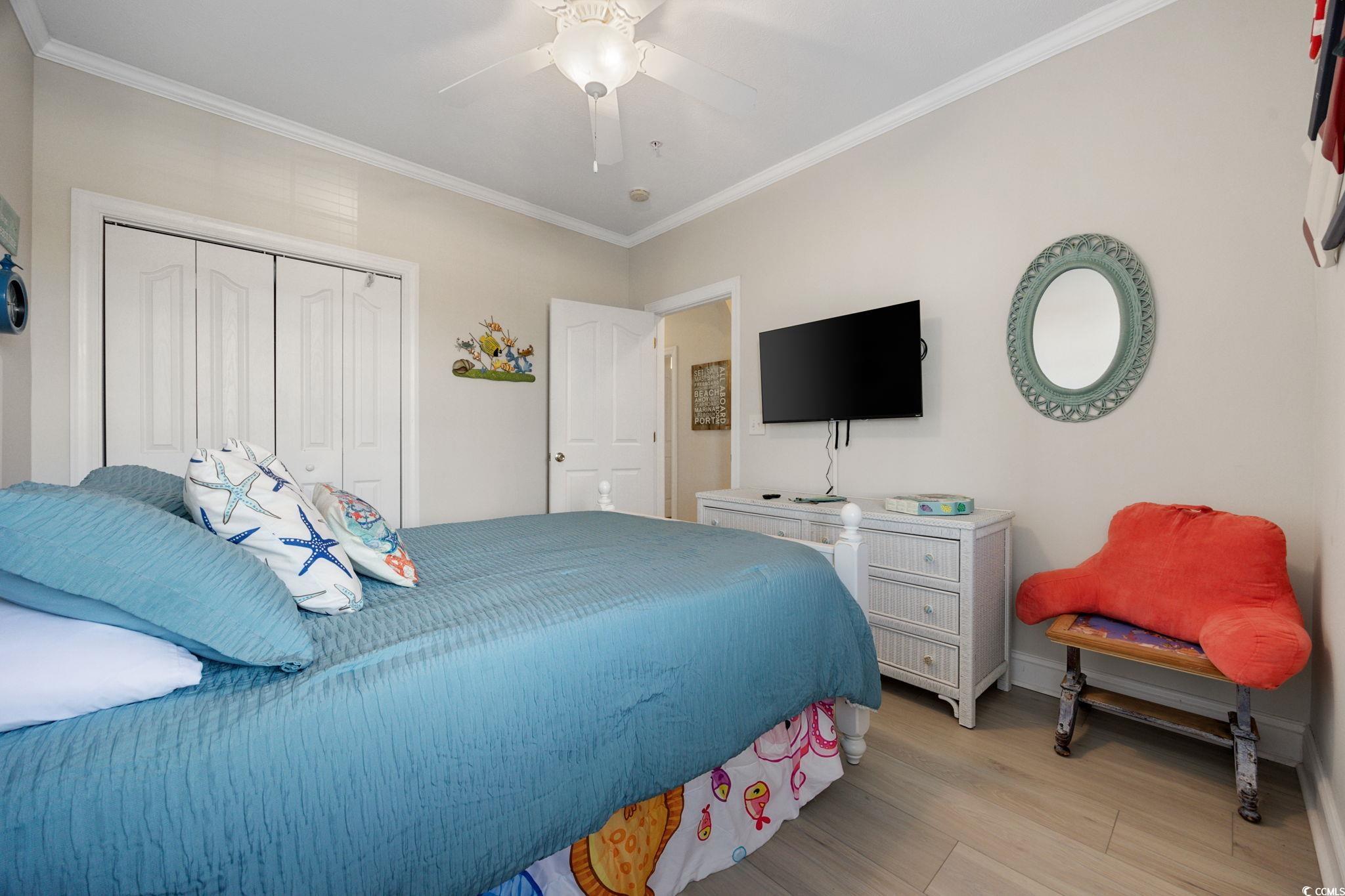 121 Waypoint Ridge Avenue, Unit P8 Little River, SC 29566 - Photo 23 of 40 Bedroom with ornamental molding, a closet, light wood-style floors, and a ceiling fan