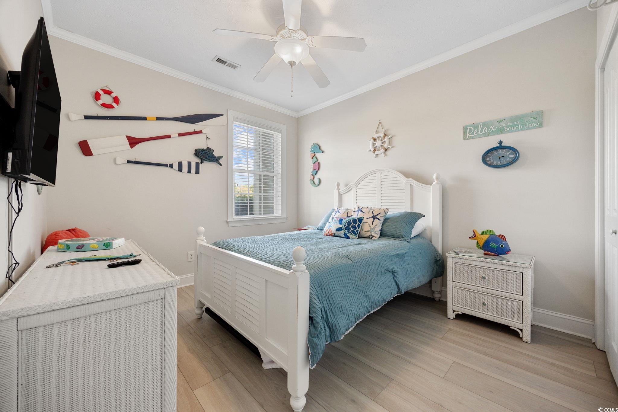 121 Waypoint Ridge Avenue, Unit P8 Little River, SC 29566 - Photo 24 of 40 Bedroom with crown molding, light wood-style floors, and ceiling fan