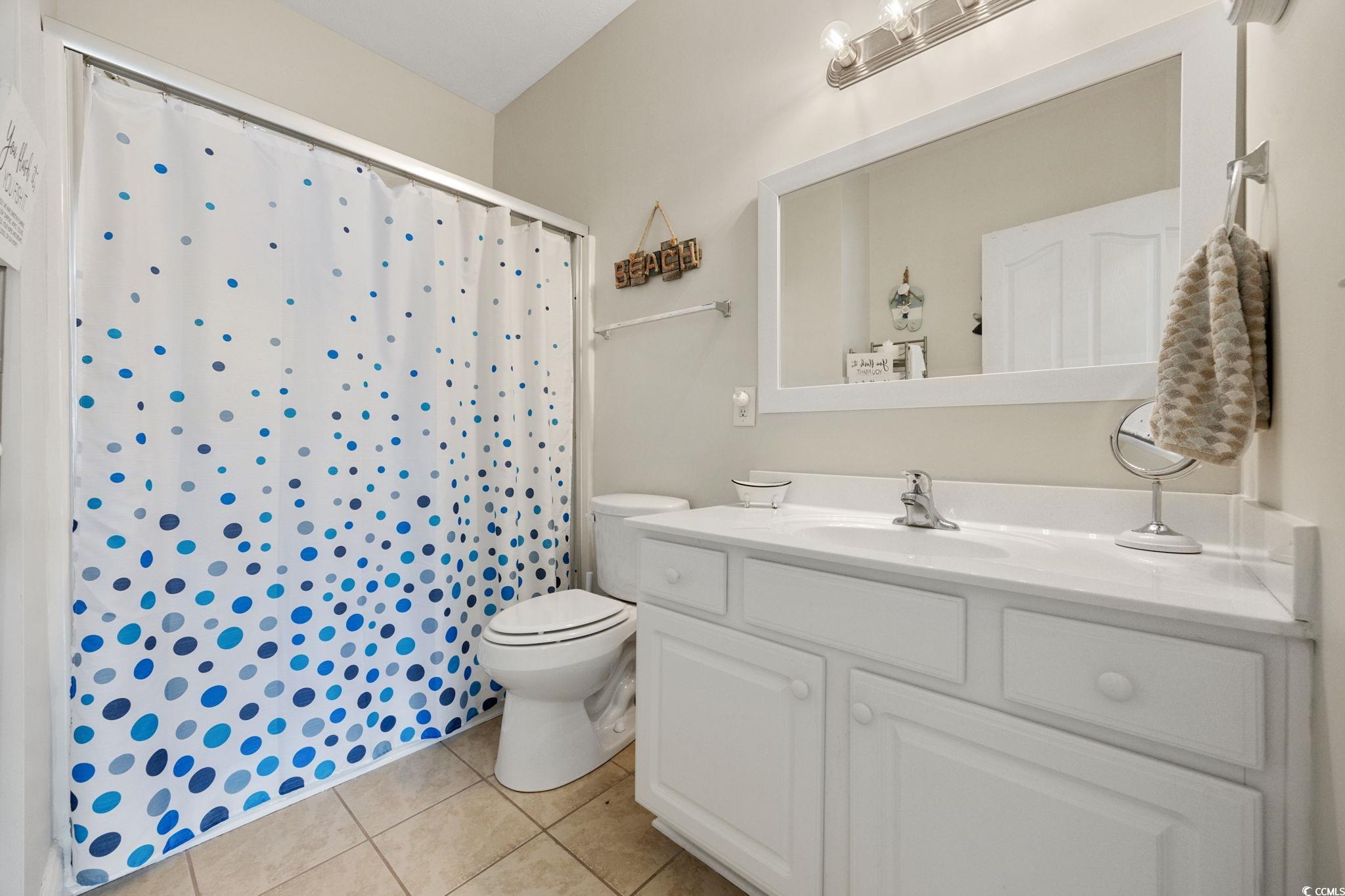 121 Waypoint Ridge Avenue, Unit P8 Little River, SC 29566 - Photo 27 of 40 Bathroom featuring a shower with shower curtain, light tile patterned floors, and vanity