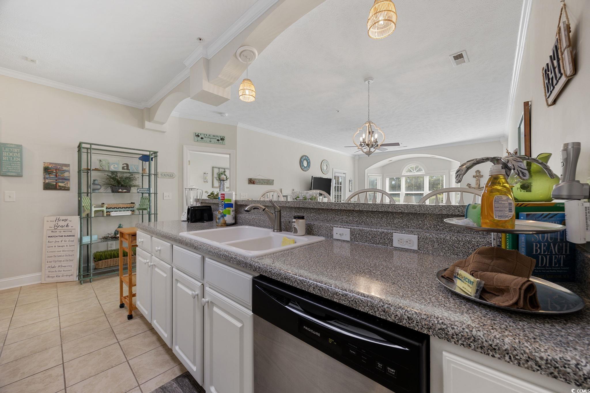 121 Waypoint Ridge Avenue, Unit P8 Little River, SC 29566 - Photo 6 of 40 Kitchen featuring white cabinets, dishwasher, ornamental molding, light tile patterned floors, and decorative light fixtures