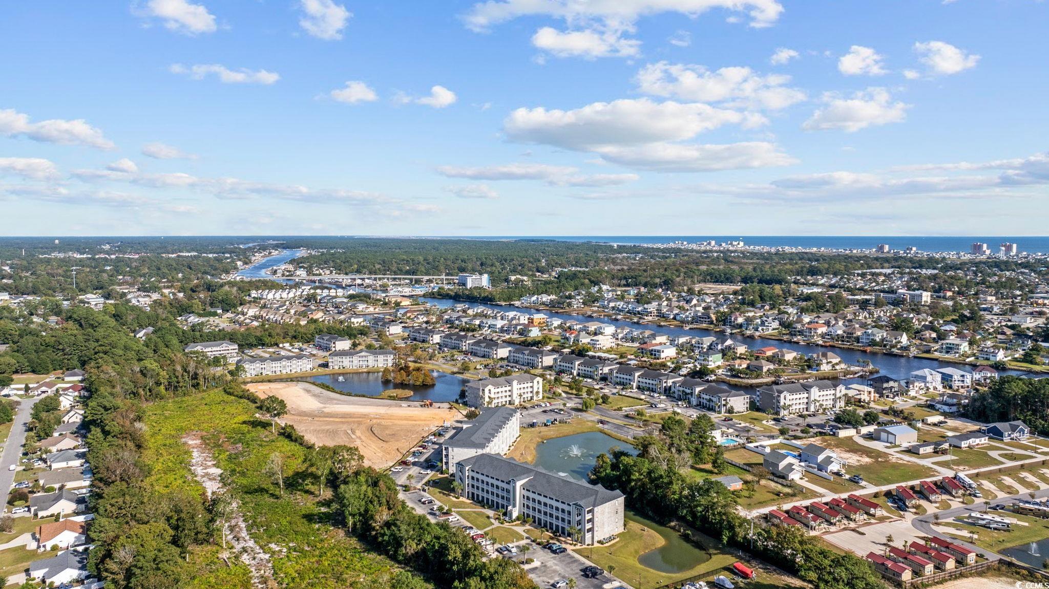 121 Waypoint Ridge Avenue, Unit P8 Little River, SC 29566 - Photo 7 of 40 Aerial perspective of suburban area featuring a large body of water