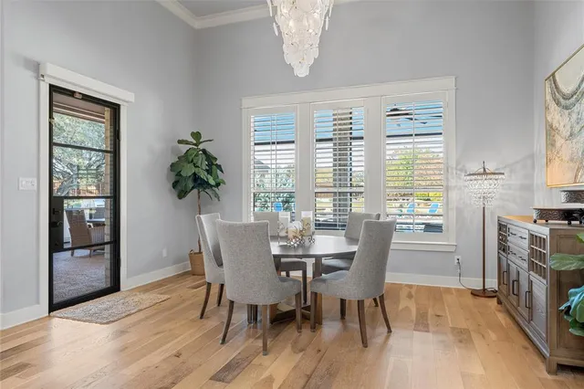 a dining room with furniture a livingroom view and wooden floor