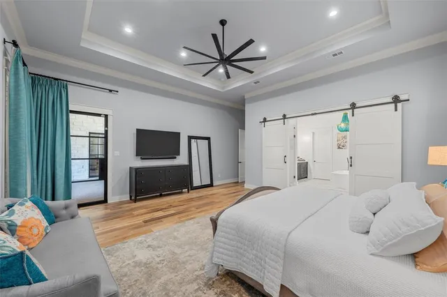 a bedroom with a bed and a chandelier