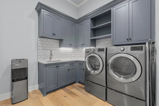 a utility room with sink dryer and washer