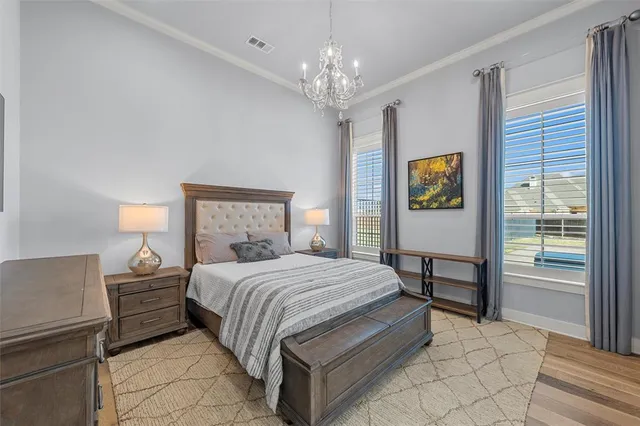 a bedroom with a bed table and window