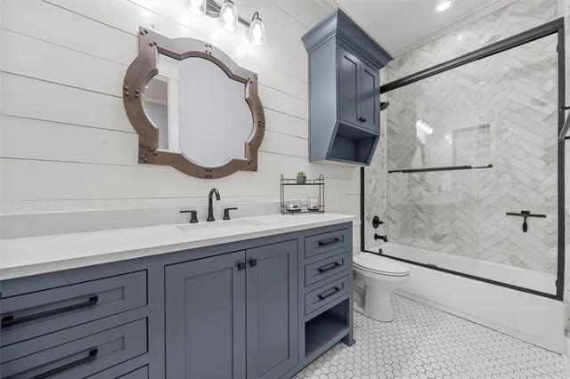 a bathroom with a double vanity sink mirror and bathtub