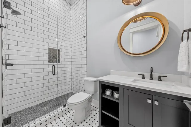 a bathroom with a toilet a sink and mirror