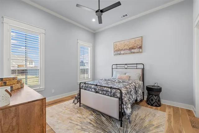 a bedroom with a bed a dresser and a window