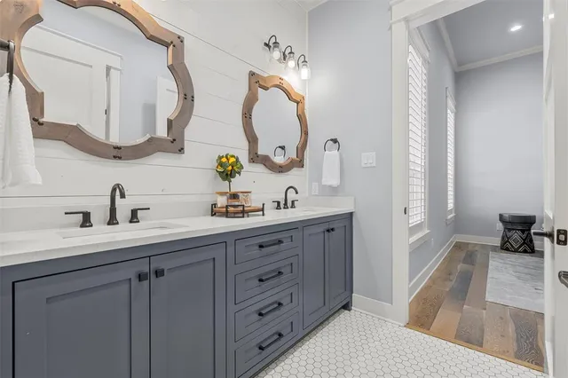 a spacious bathroom with a double vanity sink and a mirror