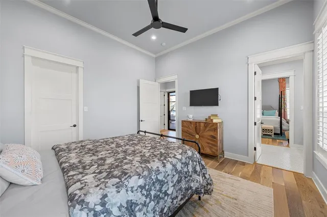 a bedroom with a large bed and a flat screen tv