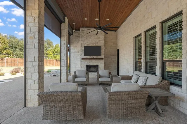 a living room with furniture a large window and a fireplace