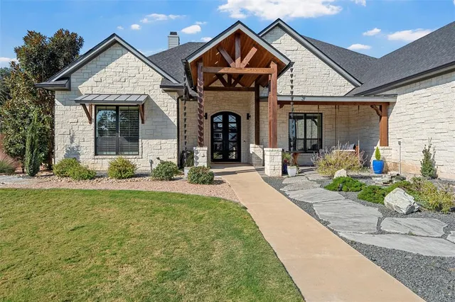 a view of a house with potted plants and a fireplace