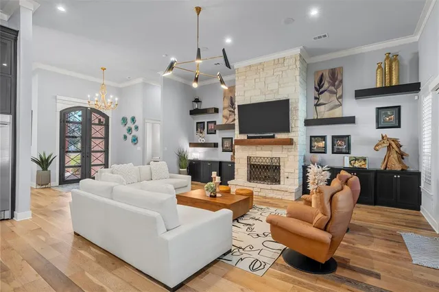 a living room with furniture a fireplace and a flat screen tv