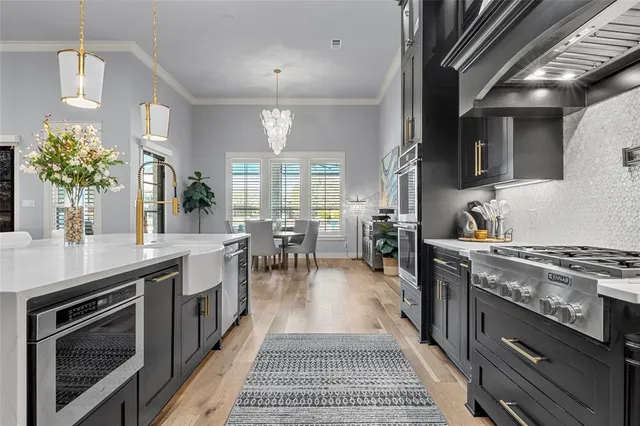 a kitchen with sink stove and cabinets