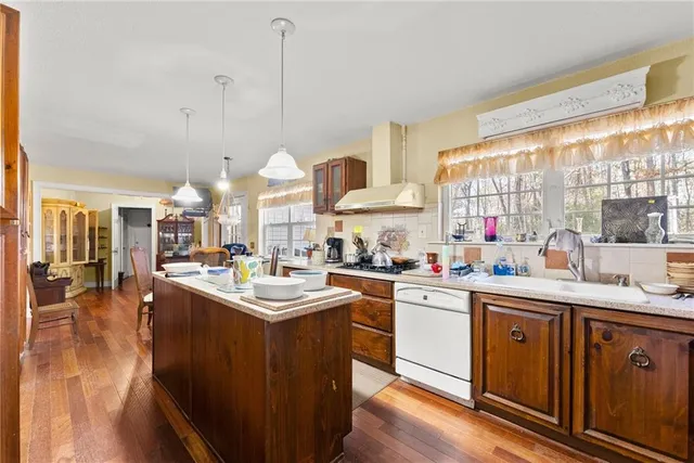 a kitchen with stainless steel appliances granite countertop a sink a stove and a refrigerator