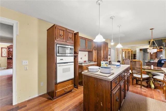 a kitchen with refrigerator cabinets and wooden floor