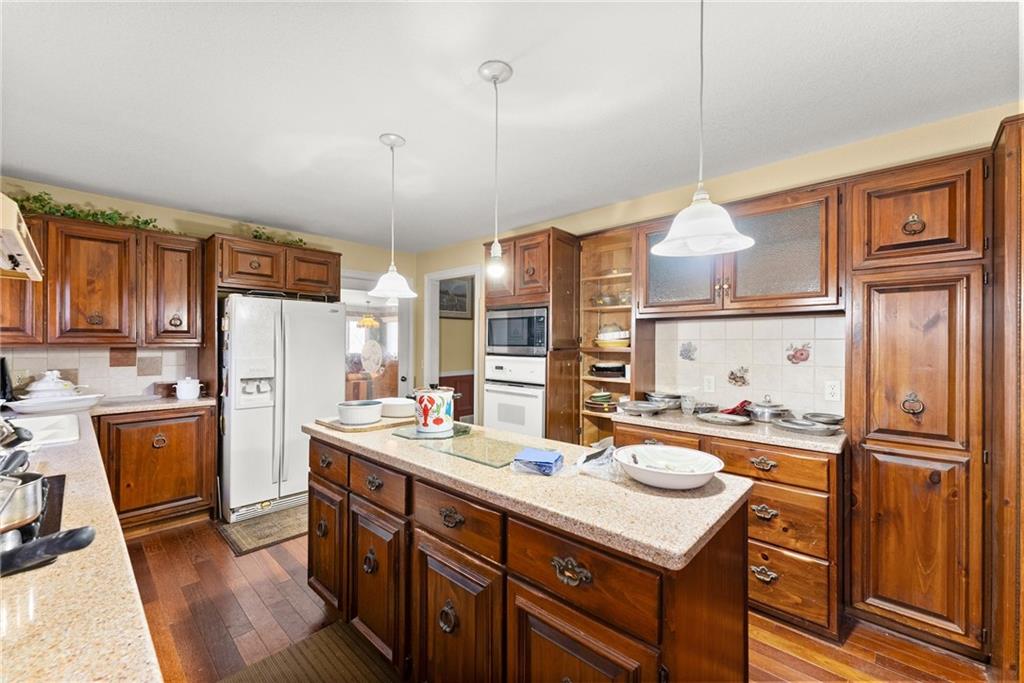 387 Smoke Rise Drive Sautee Nacoochee, GA 30571 - Photo 16 of 79 a kitchen with refrigerator cabinets and wooden floor