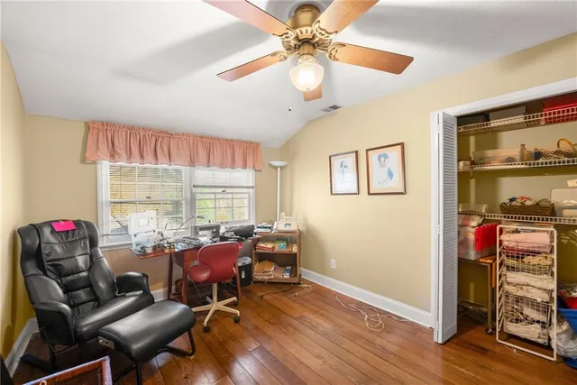 a living room with a bed and furniture flat screen tv