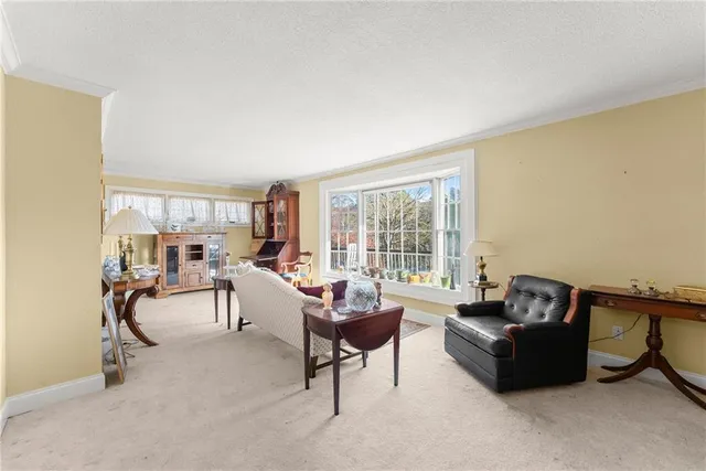 a living room with furniture and a book shelf