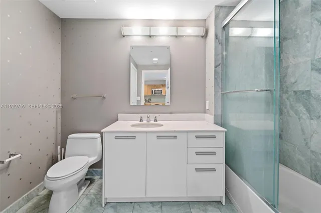 a view of bathroom with a sink and mirror