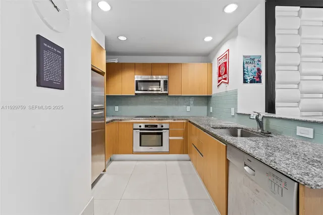 a kitchen with stainless steel appliances granite countertop a sink and a granite counter tops