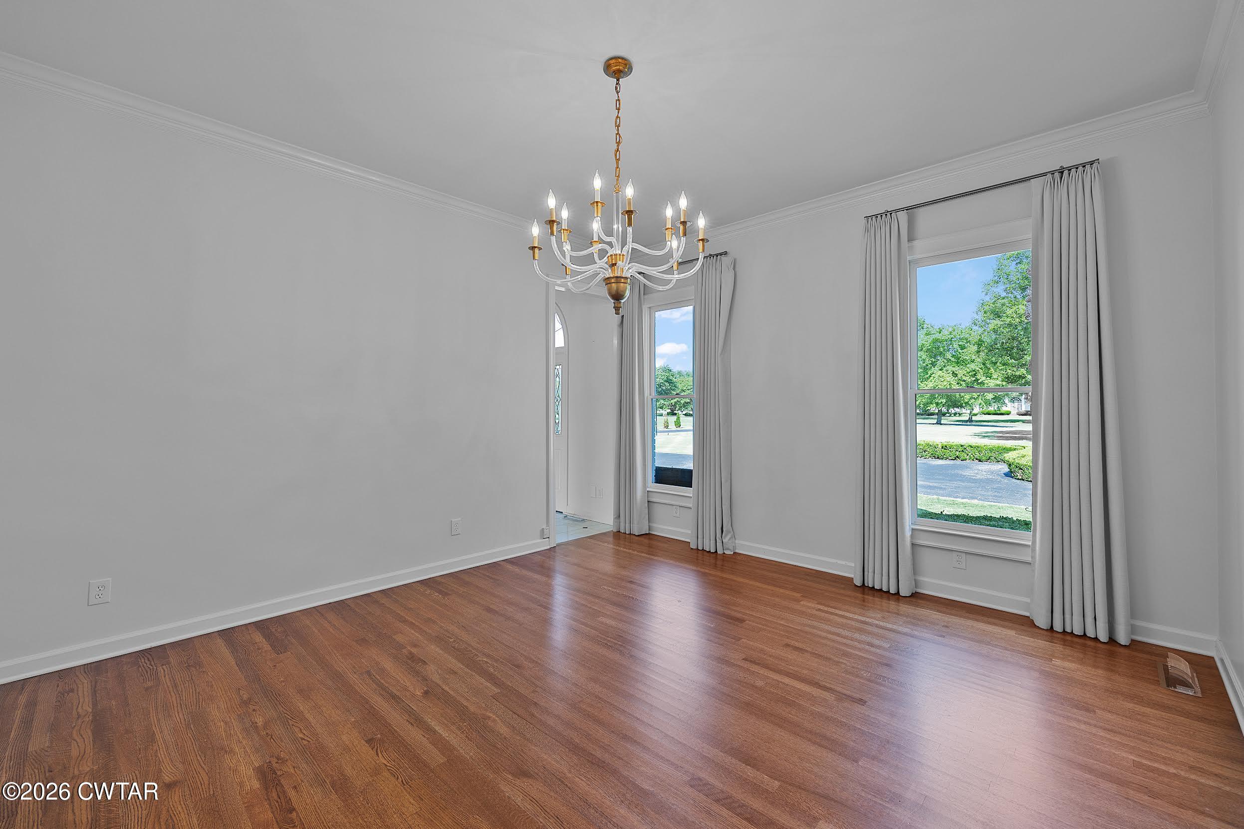 58 Huntington Place Jackson, TN 38305 - Photo 16 of 38 a view of an empty room with wooden floor and a window