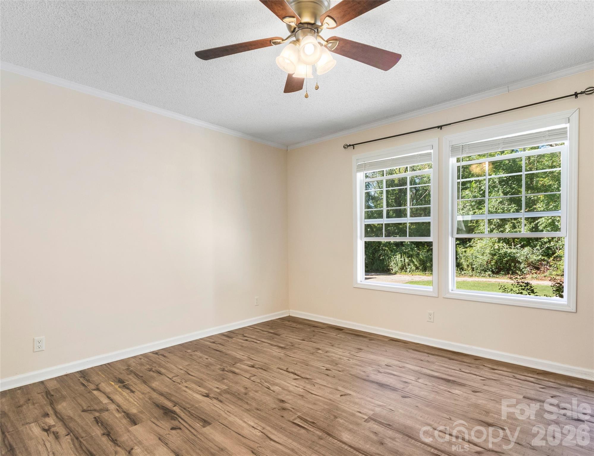 9 Sun Ridge Road Asheville, NC 28806 - Photo 12 of 29 an empty room with a window and a fan