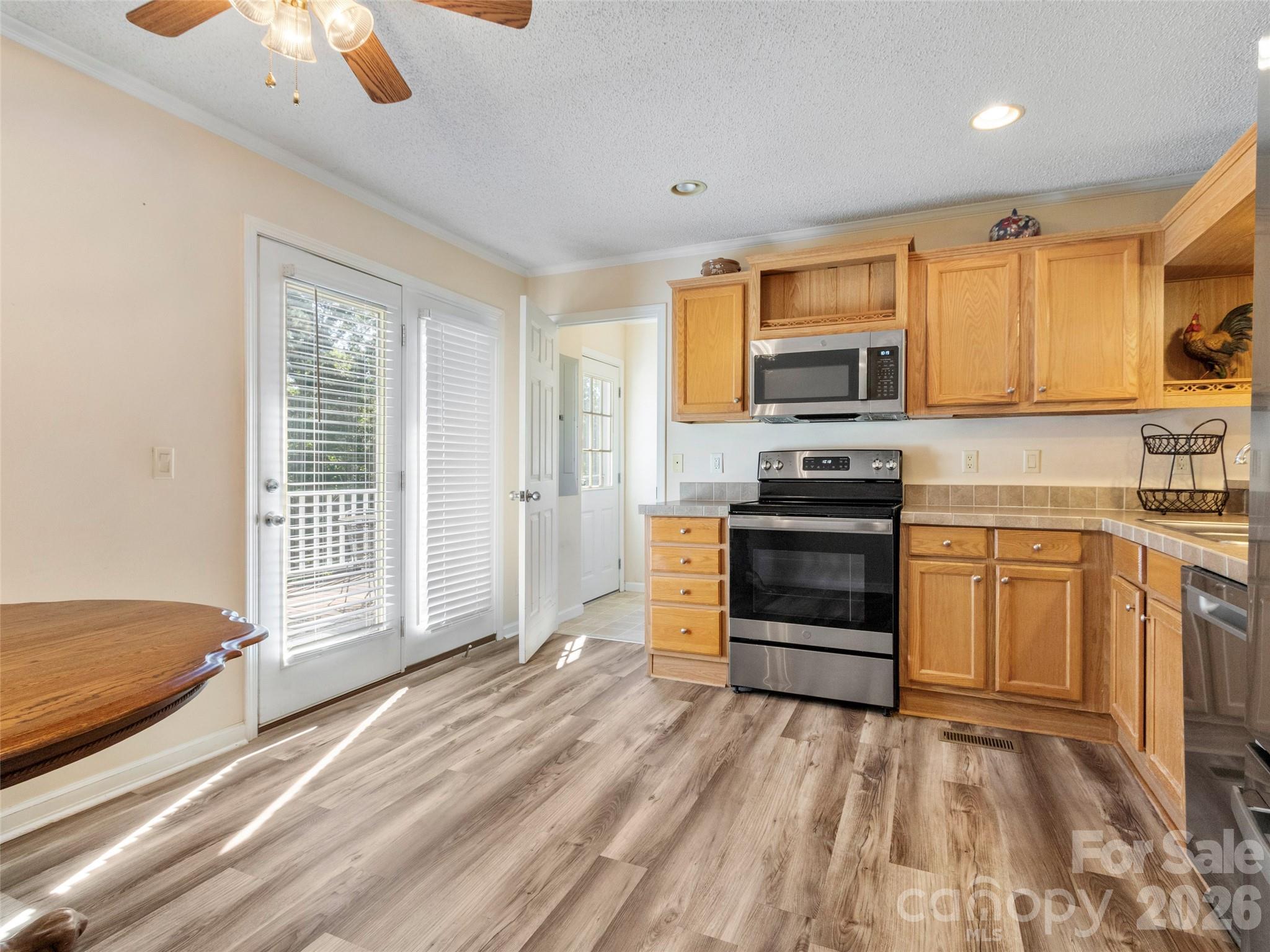 9 Sun Ridge Road Asheville, NC 28806 - Photo 6 of 29 a kitchen with stainless steel appliances kitchen island granite countertop a stove and a microwave