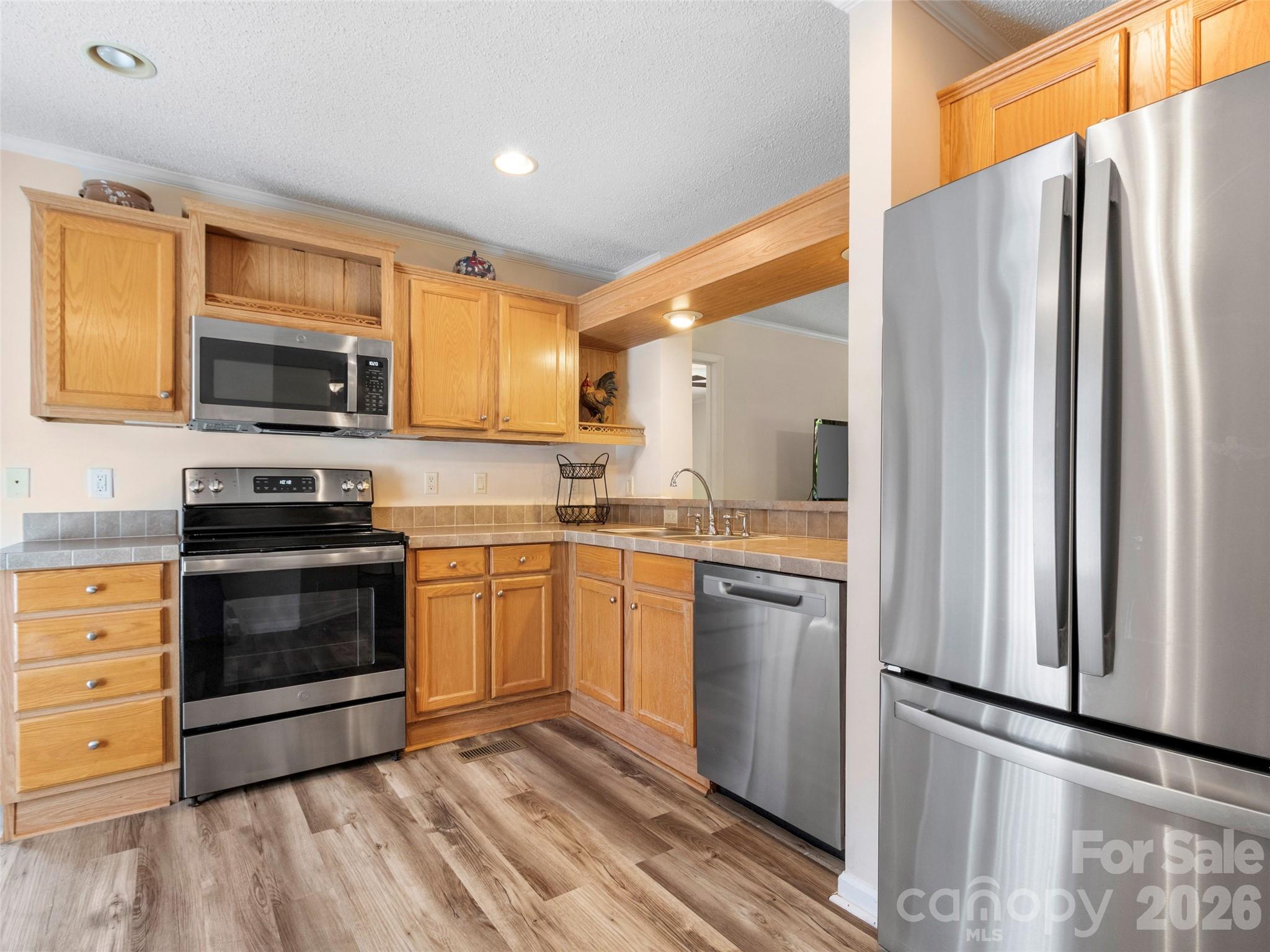 9 Sun Ridge Road Asheville, NC 28806 - Photo 7 of 29 a kitchen with granite countertop a refrigerator stove and microwave