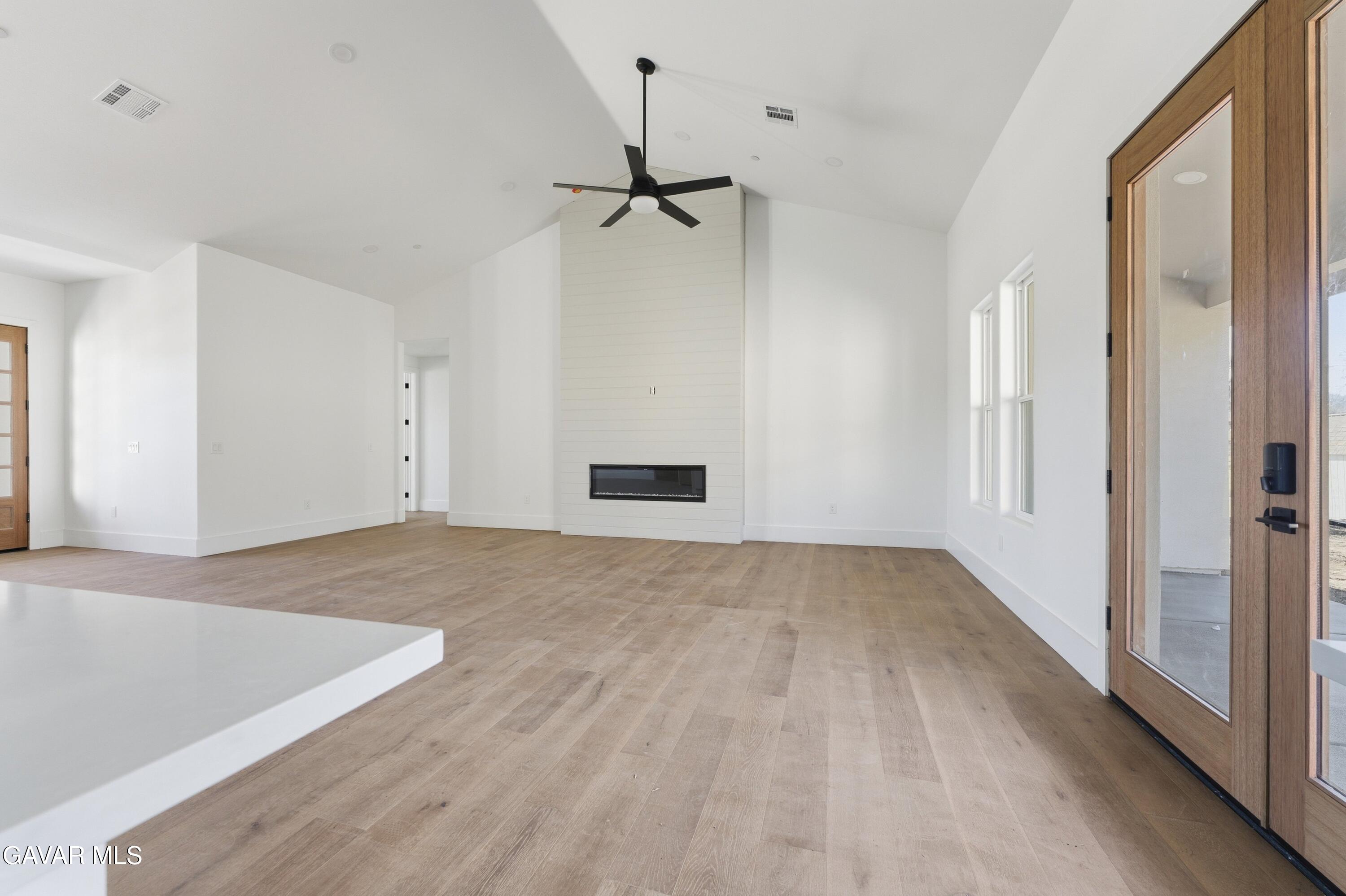 24401 Oaktree Court Tehachapi, CA 93561 - Photo 11 of 36 a view of empty room with wooden floor and fan