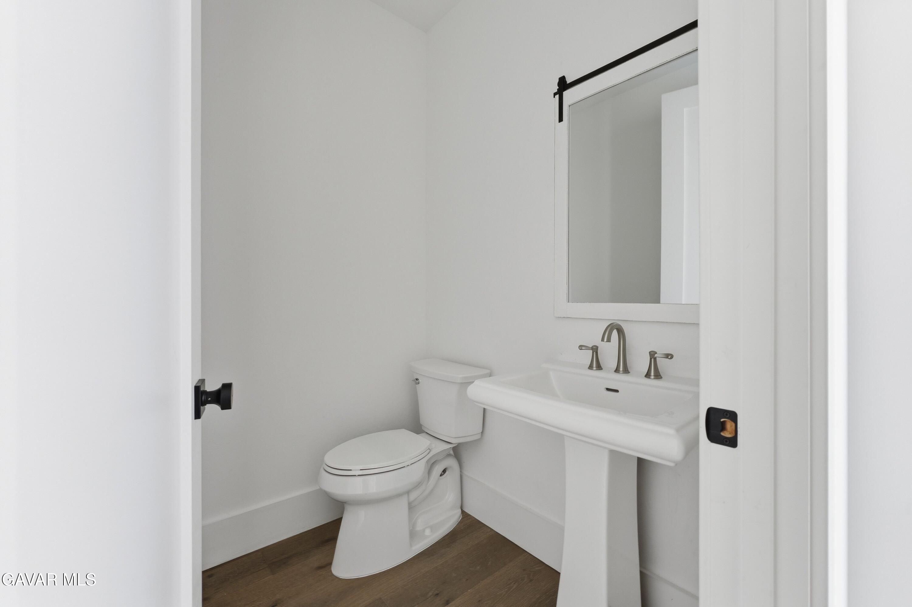 24401 Oaktree Court Tehachapi, CA 93561 - Photo 15 of 36 a white toilet sitting next to a bathroom sink