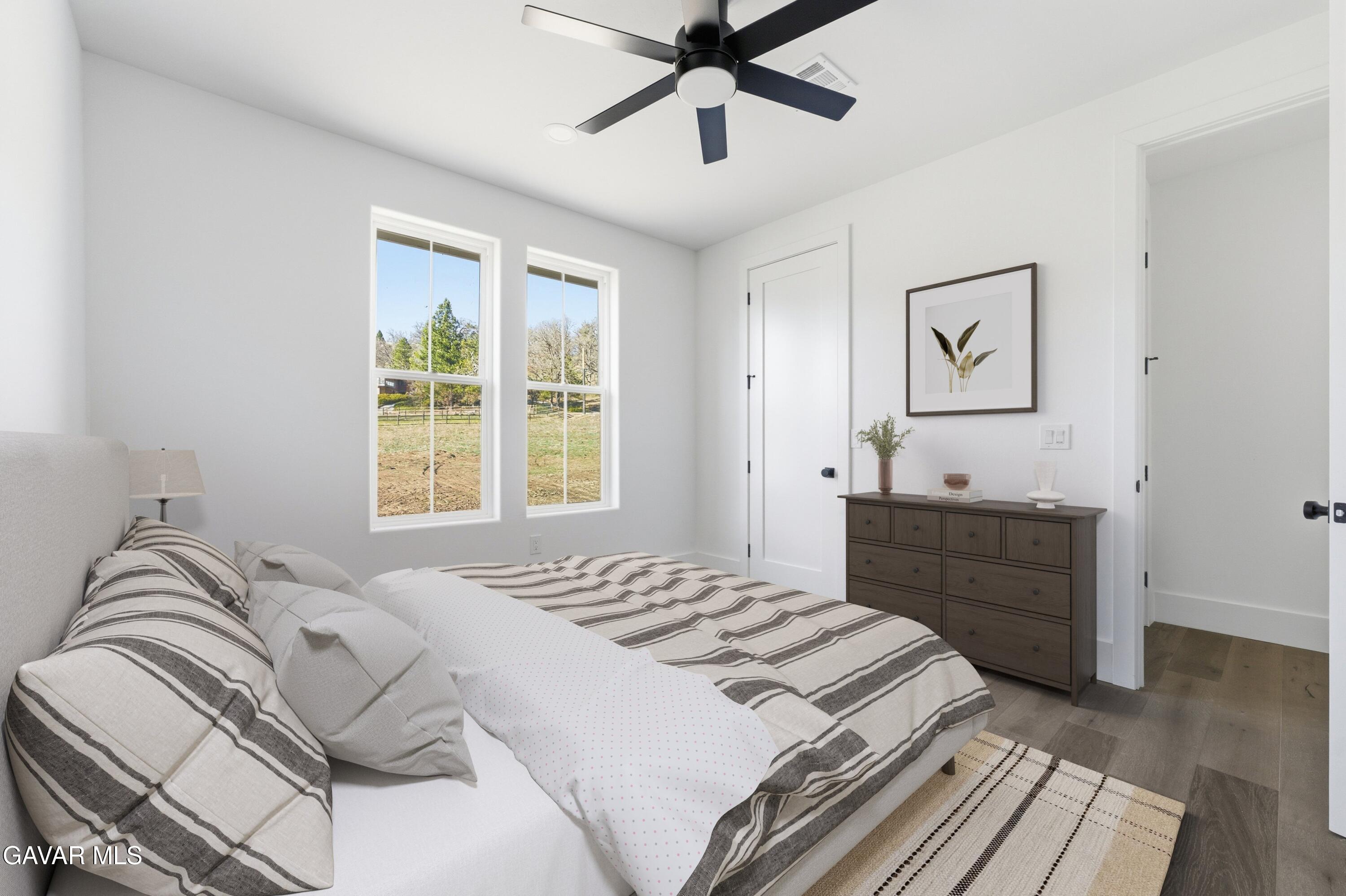 24401 Oaktree Court Tehachapi, CA 93561 - Photo 23 of 36 a bedroom with a bed and a window