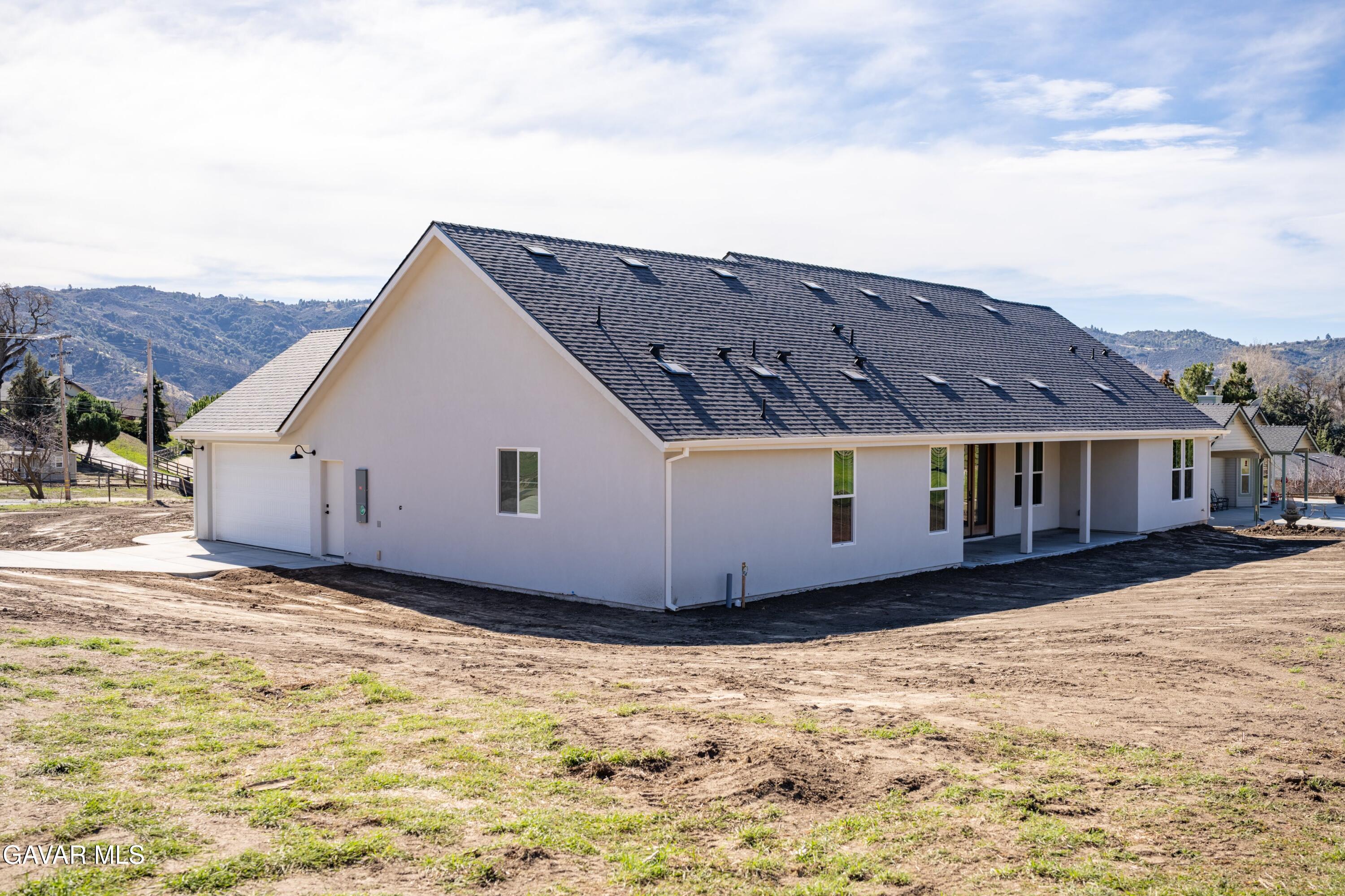 24401 Oaktree Court Tehachapi, CA 93561 - Photo 27 of 36 a view of a house with a yard
