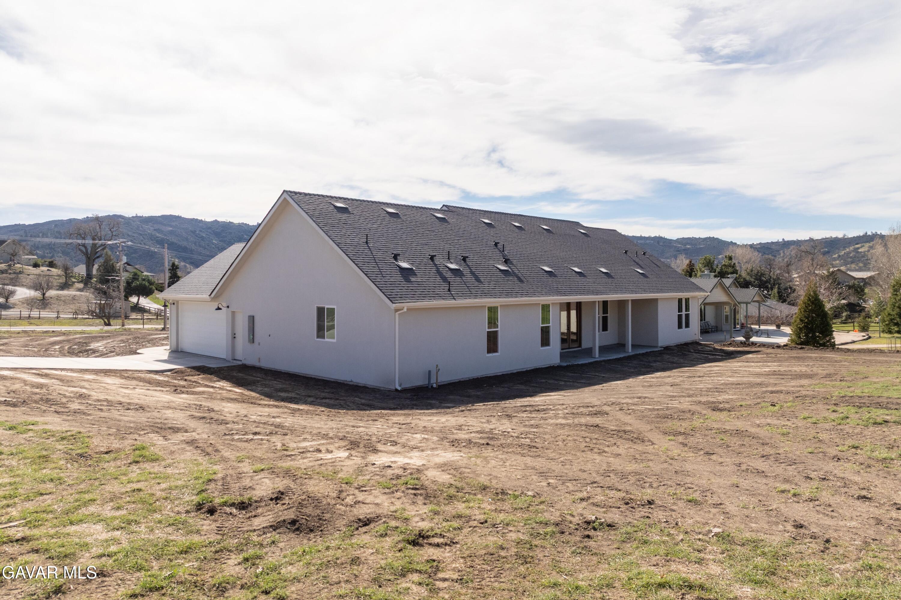 24401 Oaktree Court Tehachapi, CA 93561 - Photo 33 of 36 a view of a house with a yard