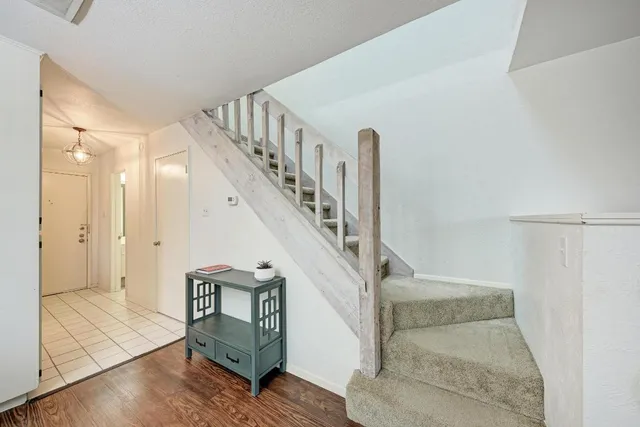 a view of entryway and hall with wooden floor
