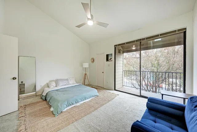 a bedroom with a large bed and a large window