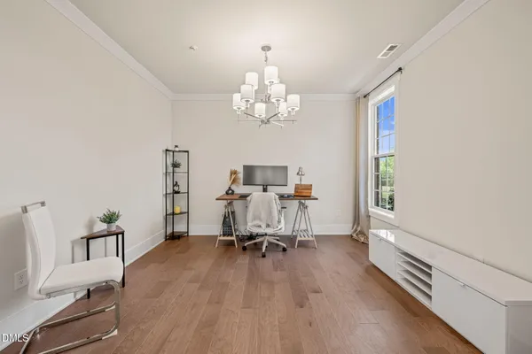 a spacious bedroom with a bed and a dresser
