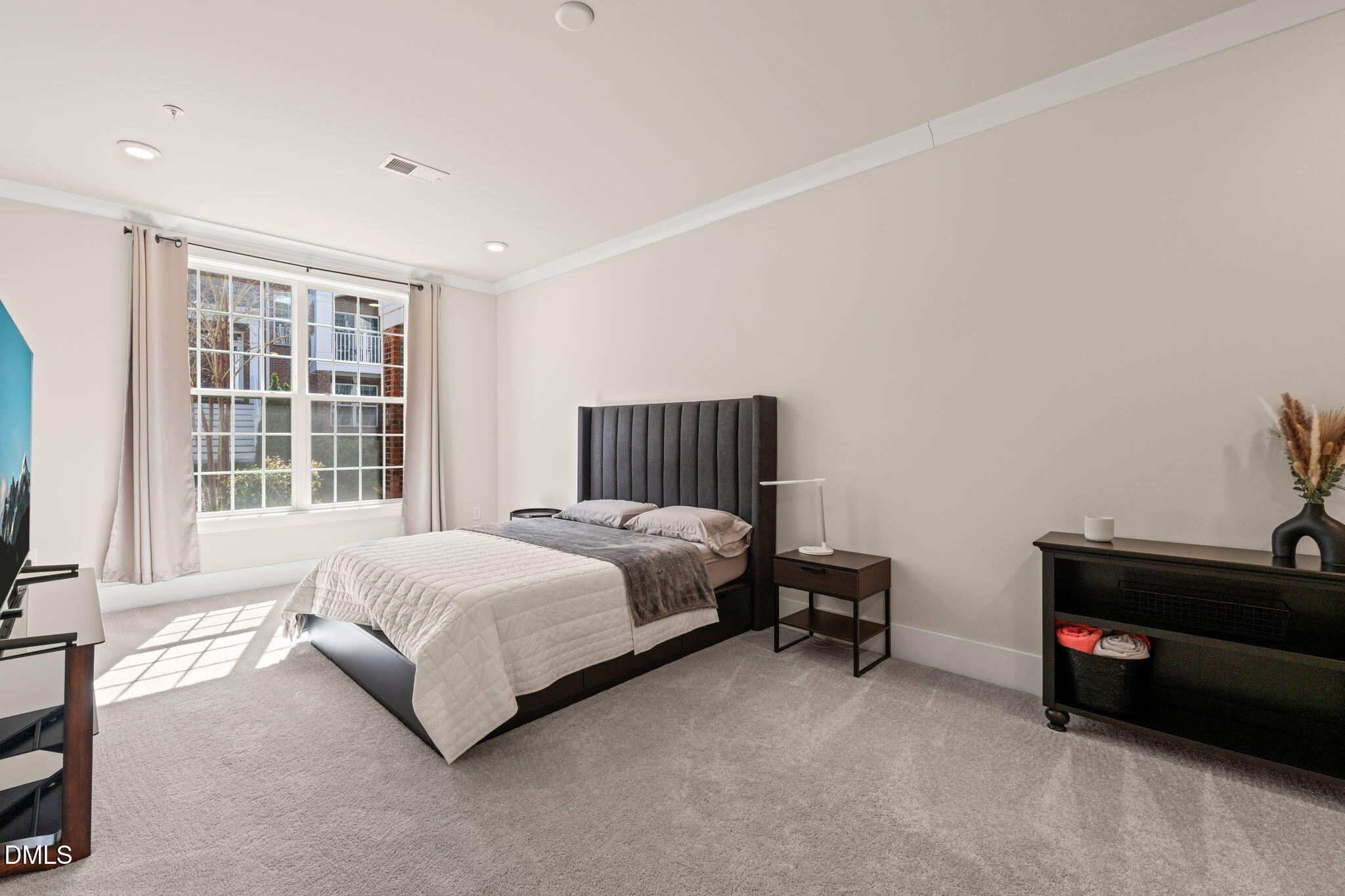 10320 Sablewood Drive, Unit 108 Raleigh, NC 27617 - Photo 13 of 34 a spacious bedroom with a bed and a window