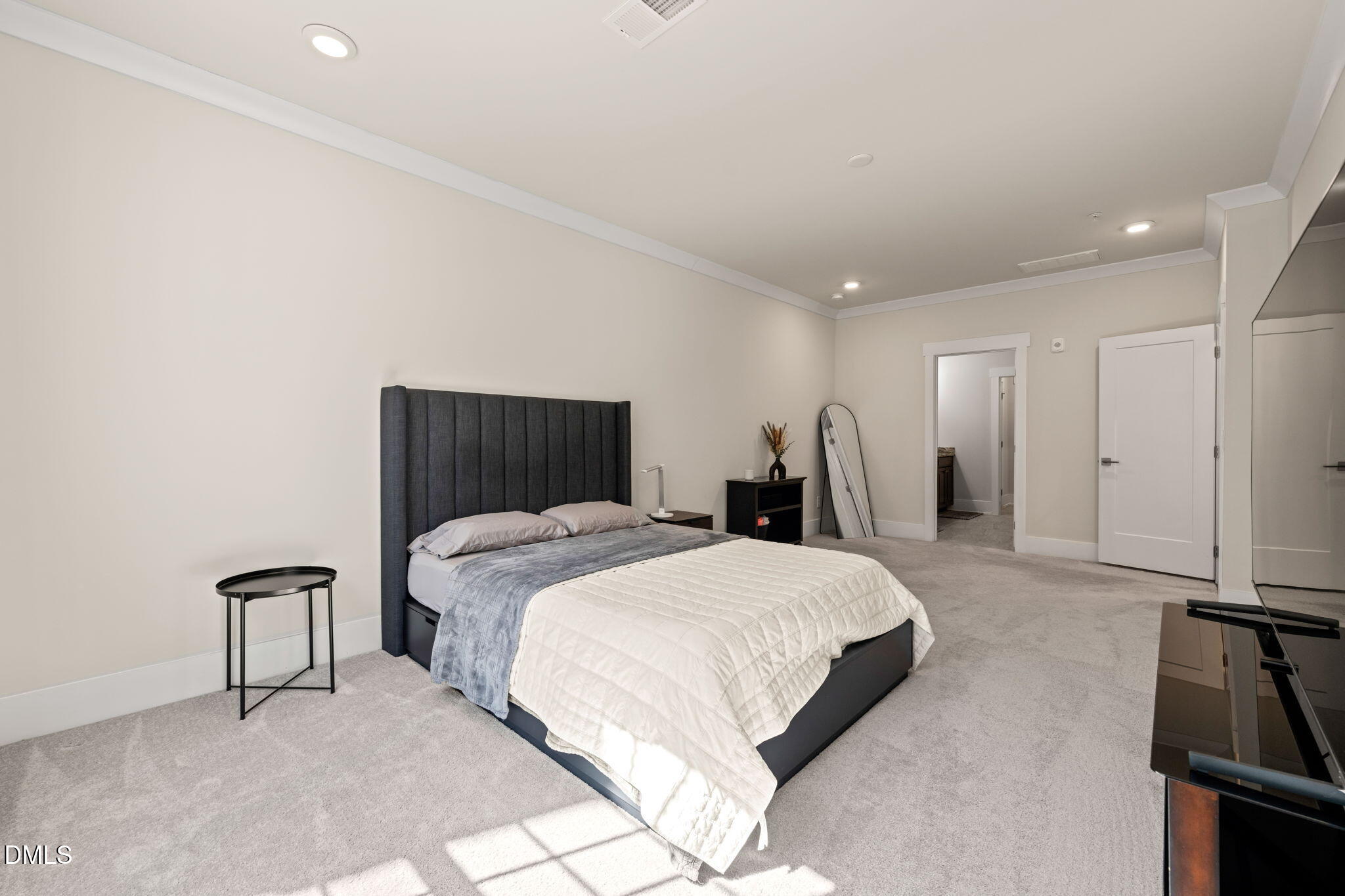 10320 Sablewood Drive, Unit 108 Raleigh, NC 27617 - Photo 14 of 34 a spacious bedroom with a bed and a dresser