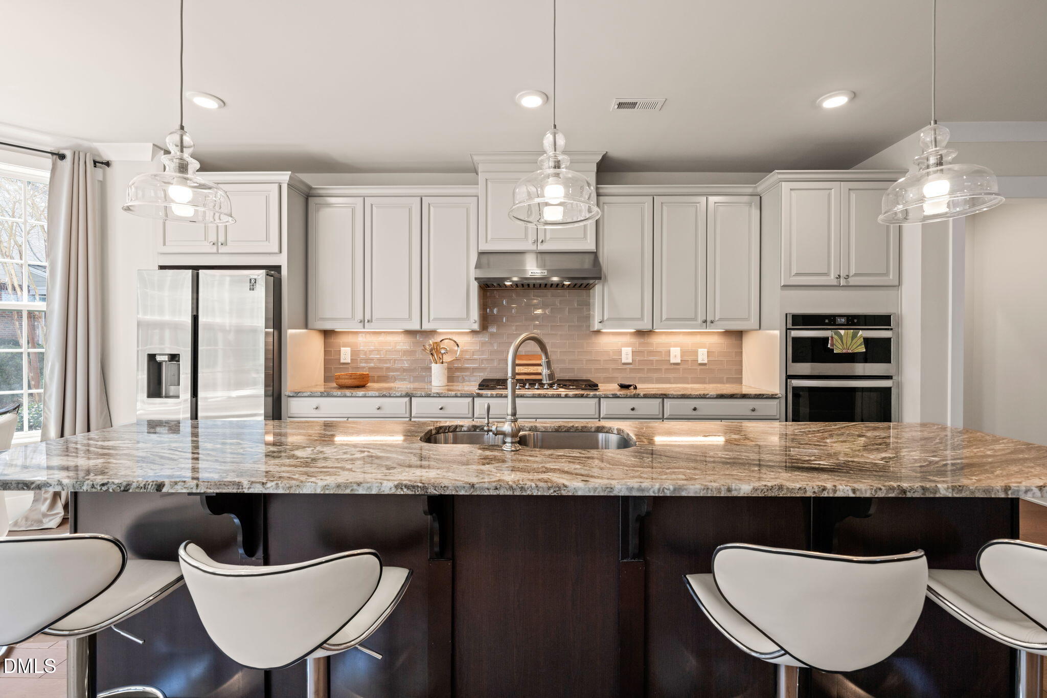 10320 Sablewood Drive, Unit 108 Raleigh, NC 27617 - Photo 5 of 34 a kitchen with granite countertop a sink a counter space appliances and cabinets