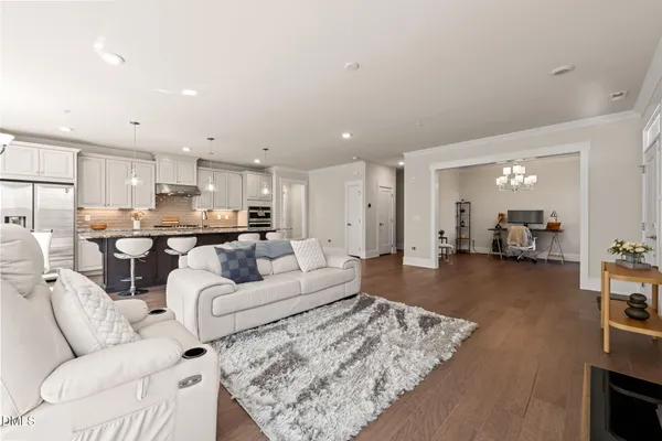 a view of a livingroom with furniture and a floor to ceiling window