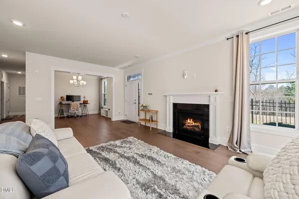 a view of a dining room with furniture a chandelier and wooden floor