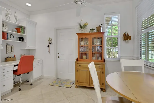 a view of a workspace with furniture and a window