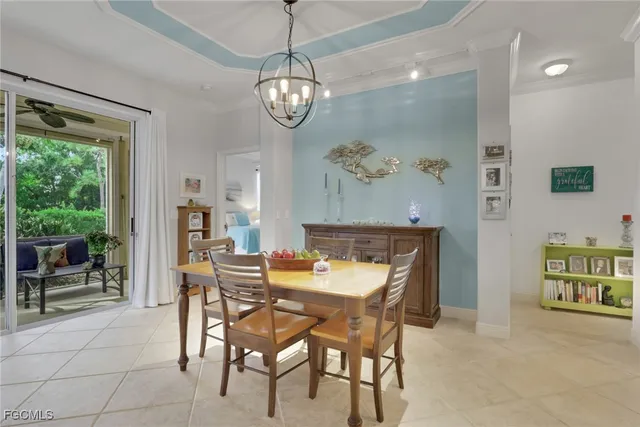 a view of a dining room with furniture and a chandelier