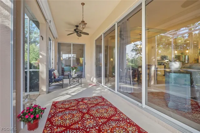 a living room with a rug floor to ceiling windows and a rug